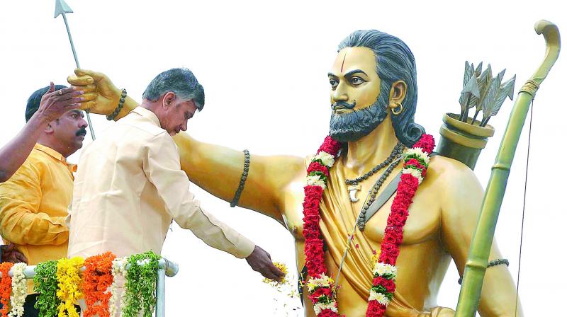 Chief Minister N. Chandrababu Naidu pays floral tributes to the statue of Alluri Sitaramaraju at Budameru bridge on the occasion of Alluris 120th birth anniversary celebrations in Vijayawada on Tuesday. (Photo: DC)