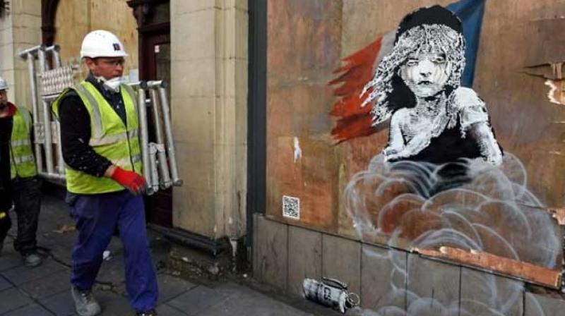 Banksys subversive art draws tourists and locals in Paris. (Photo: AFP)