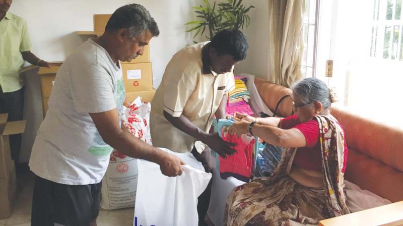 Infosys Foundation chairperson Sudha Murty helps pack relief material for flood-hit Kerala and Kodagu