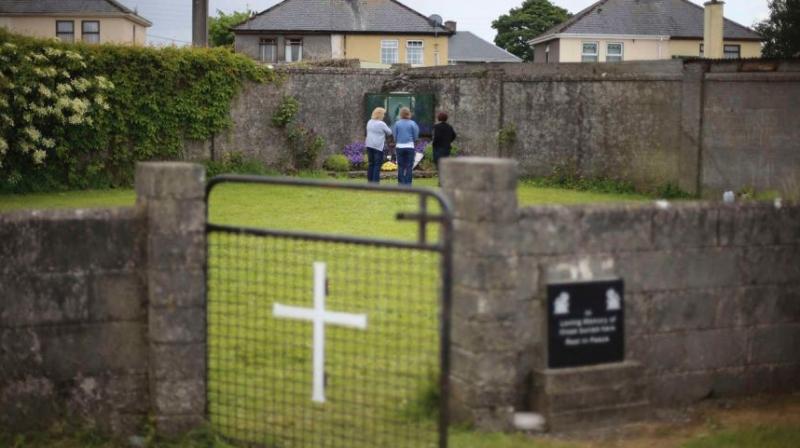 In this June 7, 2014 file photo members of the public at the site of a mass grave for children who died in the Tuam mother and baby home, in Tuam, County Galway. (Photo: AP)