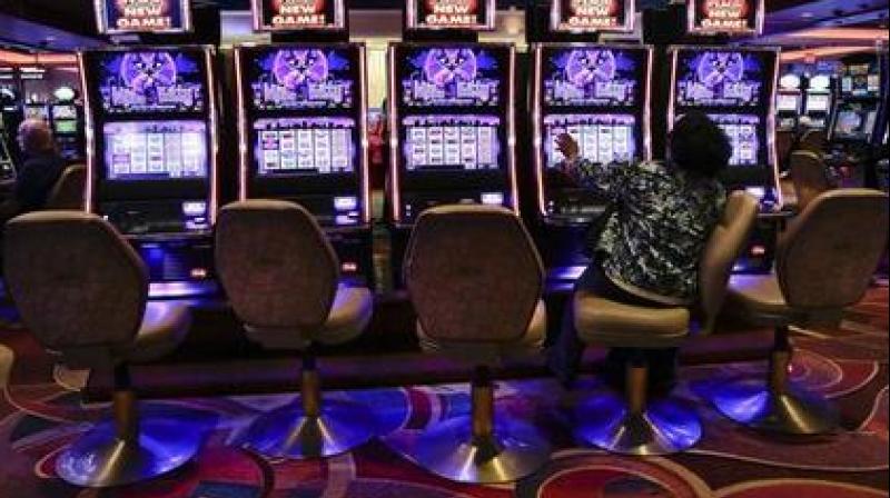 In this Oct. 3, 2014, file photo, a visitor to the Resorts World Casino at the Aqueduct racetrack plays an electronic slot machine, in the Queens borough of New York. (Photo: AP)