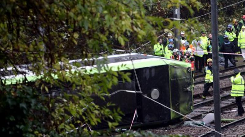 Emergency service workers attend the scene of a derailed tram in Croydon, south London. (Photo: AP)