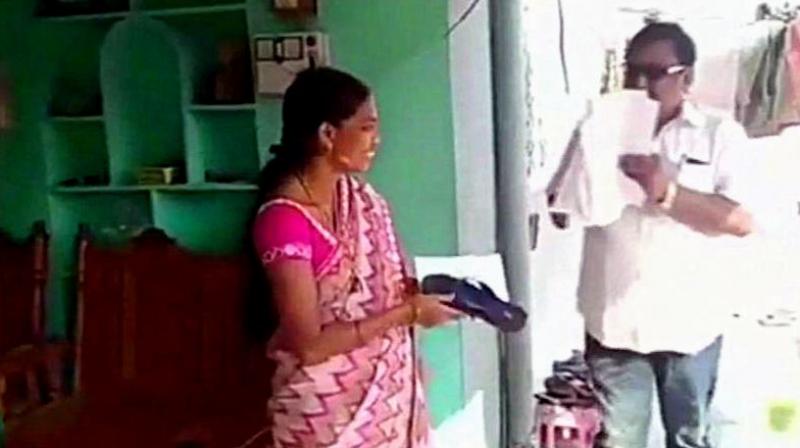 Akula Hanumanth carried out a door-to-door campaign where he has been distributing slippers and a signed slip to citizens, asking them to hit him with the same if he doesnt fulfill their expectations after winning. (Photo: ANI)