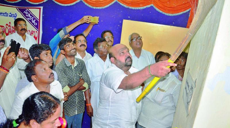 Eluru MP Venkateswara Rao cleans the premises of the district library during the National Library Week celebrations in Eluru on Tuesday.