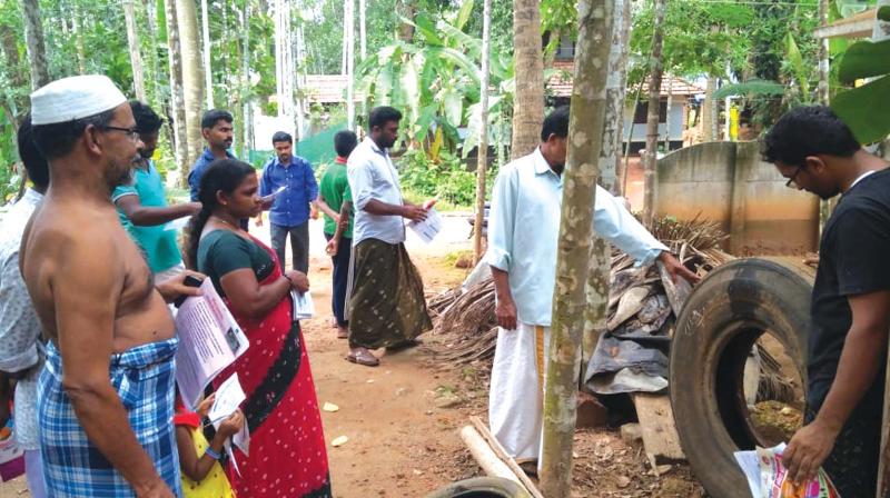 Ward members of Mavoor gram panchayat visit household at Kanniparambil in Mavvor to check out mosquito breeding sources.