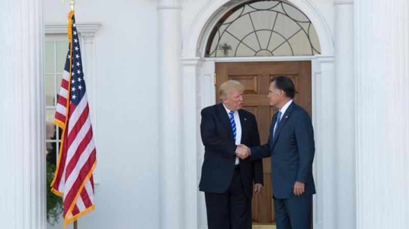 US President-elect Donald Trump shakes hands with Mitt Romney after their meeting at the clubhouse of Trump National Golf Club on November 19, 2016 in Bedminster, New Jersey. (Photo: AFP)
