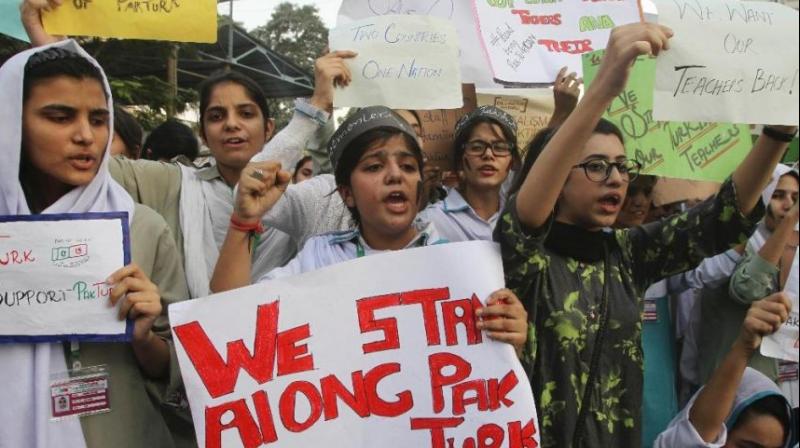 Pakistani students of the Pak-Turk International school protest in Karachi, Pakistan. (Photo: AP)