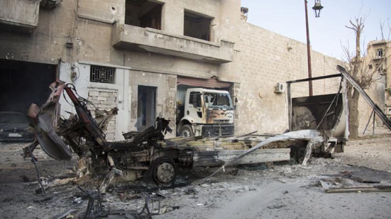 The wreackage of vehicles are seen outside a civil defence centre in Aleppo. (Photo: AFP)