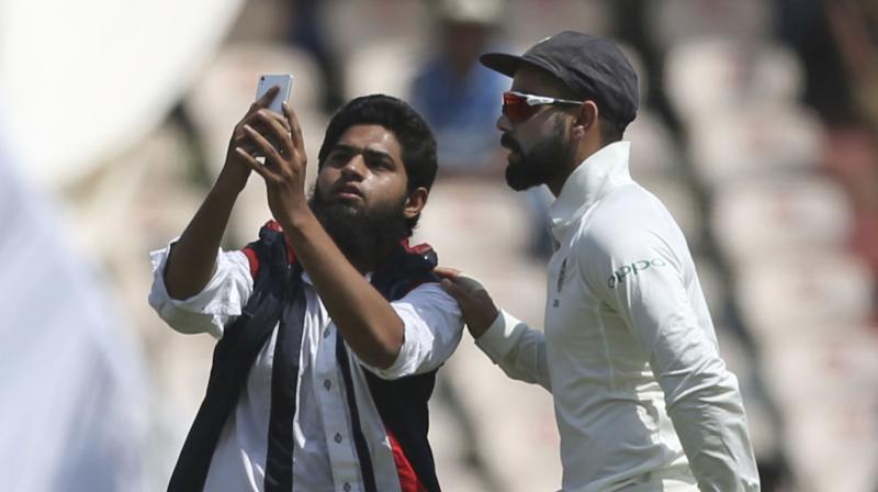 A similar incident had happened during the first Test in Rajkot also when Kohli was surrounded by two pitch invaders trying to take selfies. (Photo: AP)