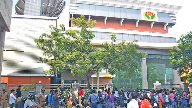 Media personnel stand guard in front of the Jaya TV where I-T officials conducted a raid, in Chennai on Thursday. (Photo: DC)