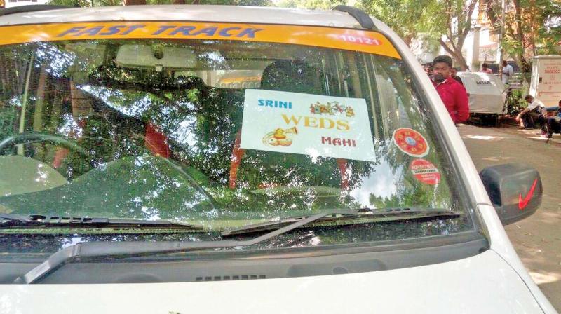 IT department officials use the poster, Srini weds Mahi on the windshields of the private cabs as undercover operation. (Photo: DC)