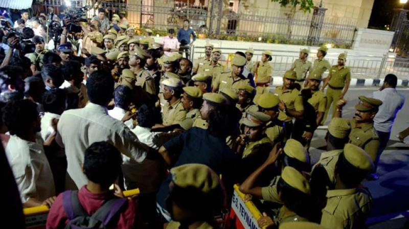 Police and media personnel outside late Tamil Nadu CM J Jayalalithaas residence at Poes Garden, where the I-T Department conducted raids on the night of 17 November. (Photo: PTI)