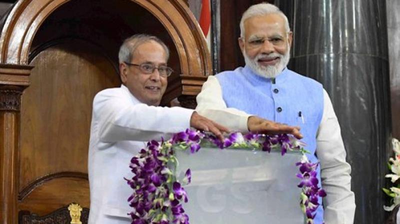 President Pranab Mukherjee and Prime Minister Narendra Modi press buttons for the launch of Goods and Services Tax (GST) at midnight, at the special ceremony in the Central Hall of Parliament in New Delhi on Saturday. (Photo: PTI)