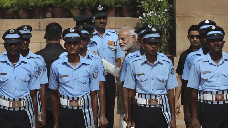Prime Minister Narendra Modi talks to an Indian Air Force officer who collapsed while standing to offer guard of honour to visiting Seychelles President Danny Antoine Rollen Faure at the presidential palace in New Delhi on Monday. (Photo: AP)