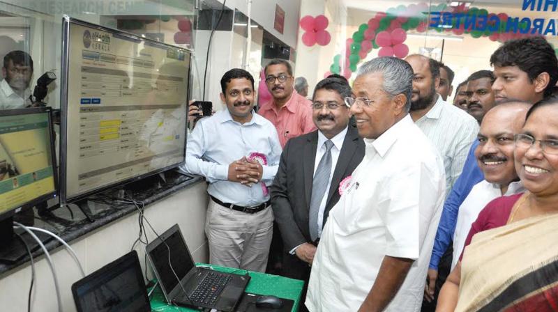 Chief Minister Pinarayi Vijayan watching the e-health platform with online registration facility introducted at Kochi Cancer Research Centre at Kalamassery during the inauguration of its OP wing in Kochi on Friday. CPM district secretary P. Rajeev, district collector K. Mohammed Y. Safirulla, V.K. Ebrahim Kunju, MLA, and  Health Minister K.K. Shylaja are also seen. (Photo: SUNOJ NINAN MATHEW)