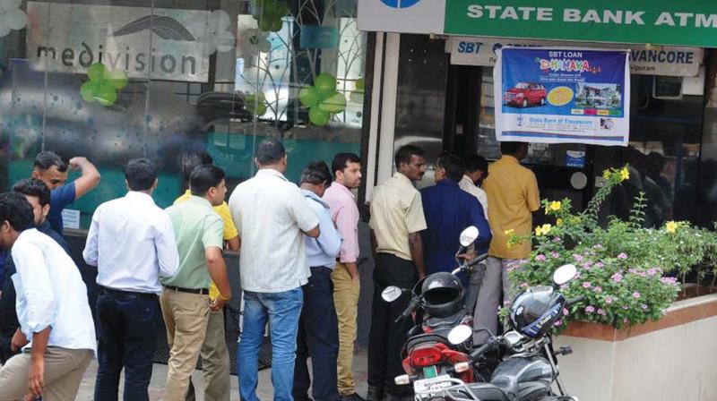 People queue up outside an ATM in Kochi on Friday. (Photo: DC)