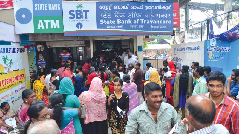 People gathered at the SBI Manacaud branch in Thiruvananthapuram on Friday. 	(Photo: Peethambaran Payyeri)