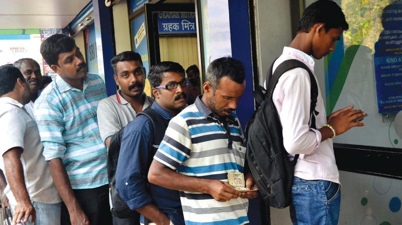 Customers in queue to deposit money at the cash deposit machine at SBI branch in Althara on Friday. ATMs in the same room did not work, Smoothening  the deposit operations.  (Photo: Peethambaran Payyeri)