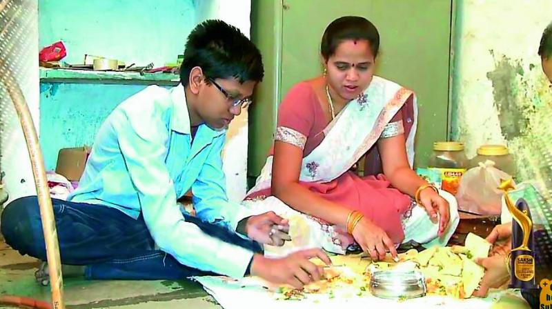 V. Mohan Abhyas lends a helping hand to his mother  to make samosas at their home. (Photo: DC)