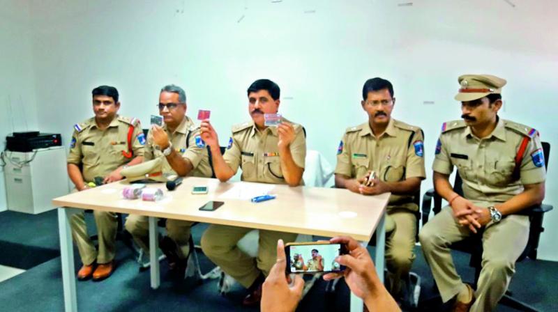 Police display debit cards seized from the accused