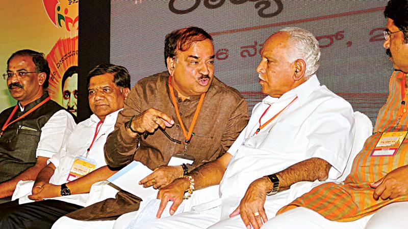 Union Minister H.N. Ananth Kumar in conversation with State BJP chief B.S. Yeddyurappa at a training camp of the party in Bengaluru on Thursday. Party leaders Jagadish Shettar and Aravind Limbavali are seen. (Photo: KPN)