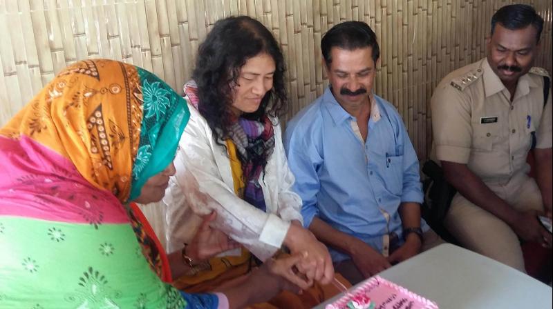 Activist Irom Sharmila cuts cake with friends on her 45th birthday at the Santhigramam rehabilitation centre at Madathukkad, Kerala. (Photo: PTI)