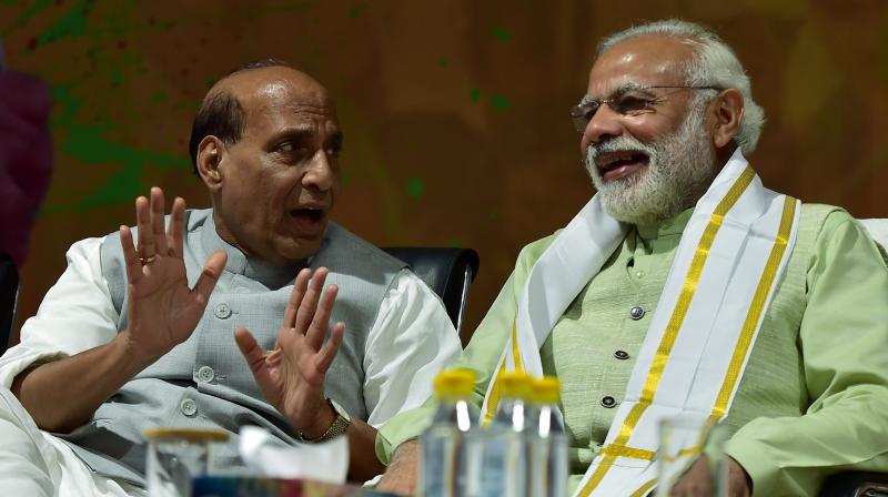 Prime Minister Narendra Modi and Union Home Minister Rajnath Singh at the party headquarters to celebrate victory in UP and Uttrakhand Assembly elections, in New Delhi. (Photo: PTI)