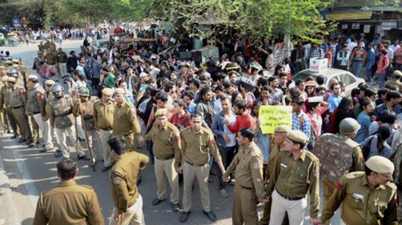 AISA members marching towards Maurice Nagar police station to file a case against ABVP activists in New Delhi. (Photo: PTI)