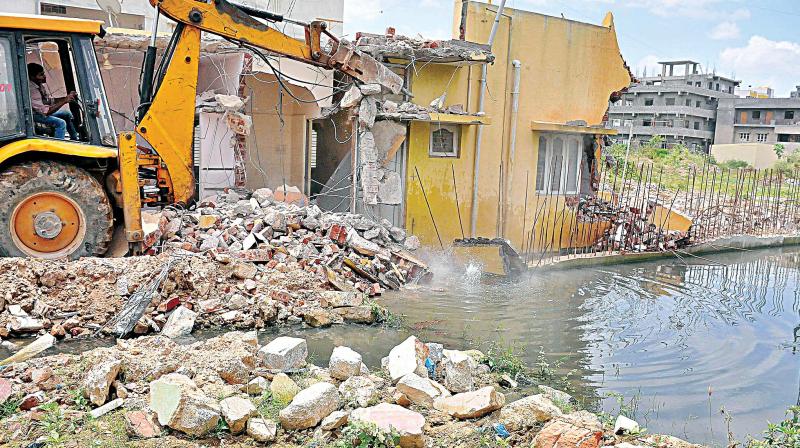 A file photo of BBMP clearing a drain encroachment