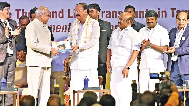 Vice President M. Venkaiah Naidu releases a book during the felicitation programme to mark the successful completion of 1,000 liver transplants in Tamil Nadu by Dr Mohamed Rela on Tuesday. 	(Photo: DC)