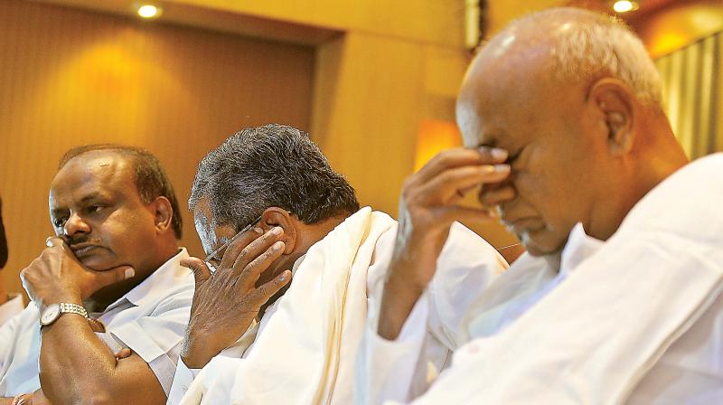 (From L) Chief Minister H.D. Kumaraswamy, former chief minister Siddaramaiah and JD(S) supremo H.D. Deve Gowda at a joint press conference in Bengaluru on Saturday.  (DC)