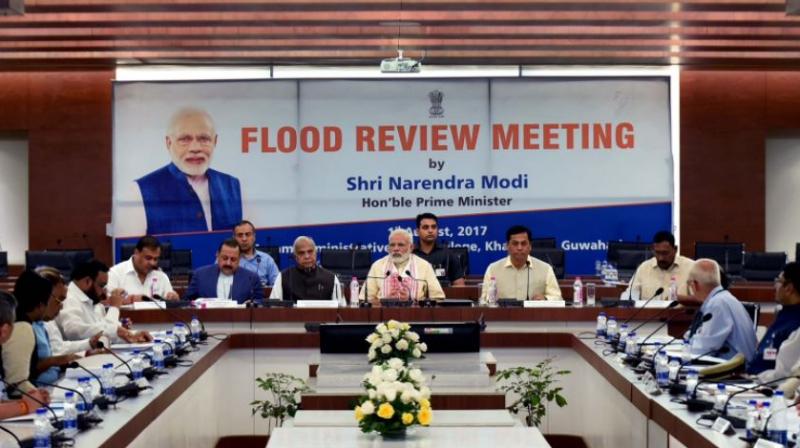 Prime Minister Narendra Modi, Assam CM  Sarbanand Sonwal, Ministers from the Centre and Assam, officials review the flood situation in the state. (Photo: Narendra Modi | Twitter)