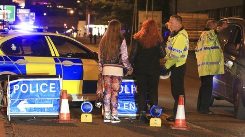 Police work at Manchester Arena after reports of an explosion at the venue during an Ariana Grande gig in Manchester, England Monday. (Photo: PTI)