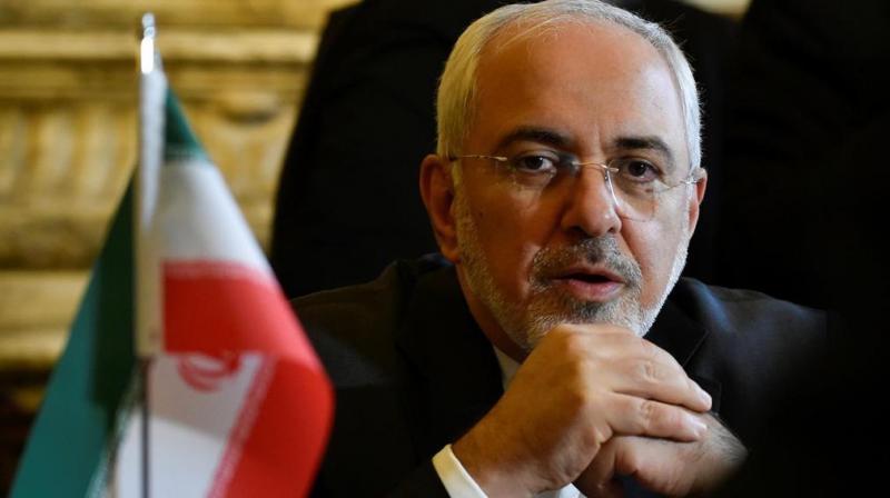 Zarif told reporters that Iran is not seeking to acquire a nuclear bomb, but that its \probable\ response to a US withdrawal would be to restart production of enriched uranium. (Photo: AFP)