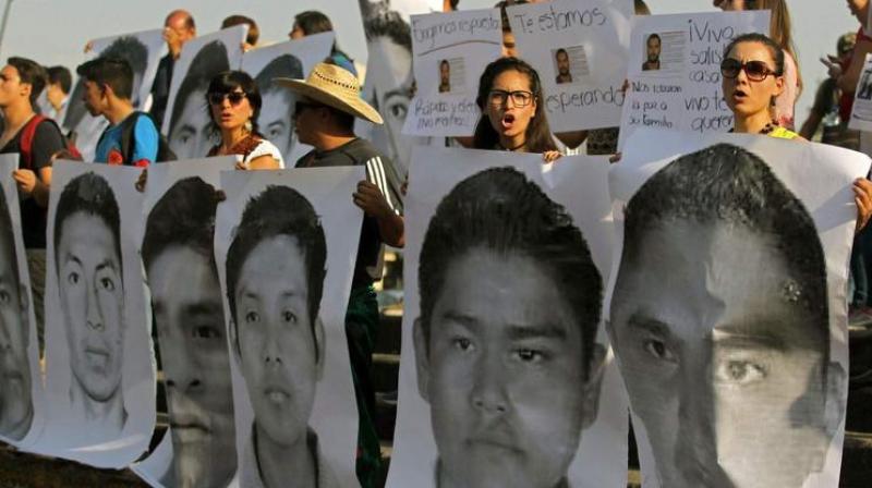 Relatives and friends of three missing students from the University of Audiovisual Media take part in a demonstration April 19 in Guadalajara demanding that their loved ones be returned alive. On Monday, authorities said the three had been killed, probably by a drug cartel. (Photo: AFP)