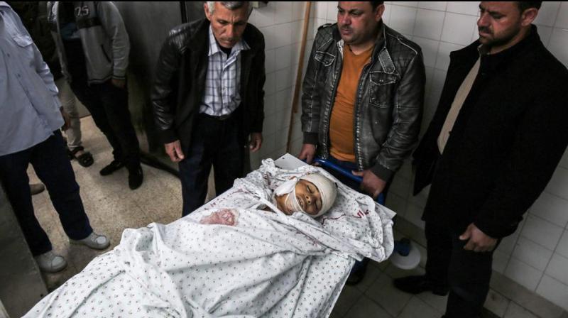 Relatives of 15-year-old Palestinian teenager Azzam Oweida gather around his body in the morgue of a hospital in Khan Yunis in the southern Gaza Strip on April 28, 2018, as he succumbed to his wounds a day after he was shot by Israeli forces in clashes along the Gaza border. (Photo: AFP)