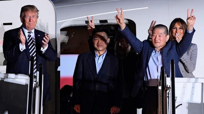 Donald Trump applauds as US detainees Tony Kim, Kim Hak-song and Kim Dong-chul arrive on US soil.  (Photo: AFP)
