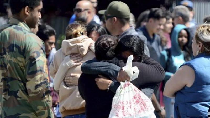 Students are reunited with family members outside Highland High School in Palmdale, California. (Photo: AP)