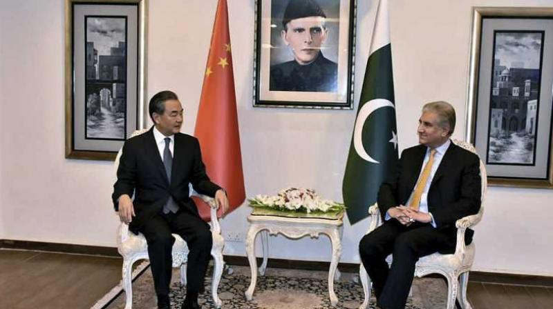 In this picture released by Press Information Department, visiting Chinese foreign minister Wang Yi, left, meets with his Pakistani counterpart Shah Mahmood Qureshi, in Islamabad.  (Photo: AP)