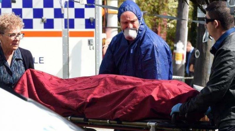 Forensic police (C) and other officials remove a dead body from the crime site in the suburb of Australias western city of Perth on September 10, 2018. (Photo: AFP)