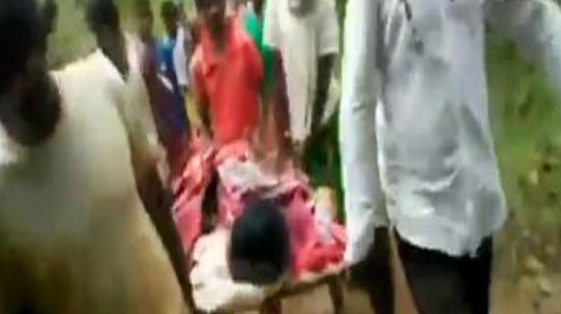 The lack of adequate connectivity forced locals to carry the ailing individual on a cot for over one kilometre to reach the district hospital, as no ambulance could reach the location. (Photo: ANI)