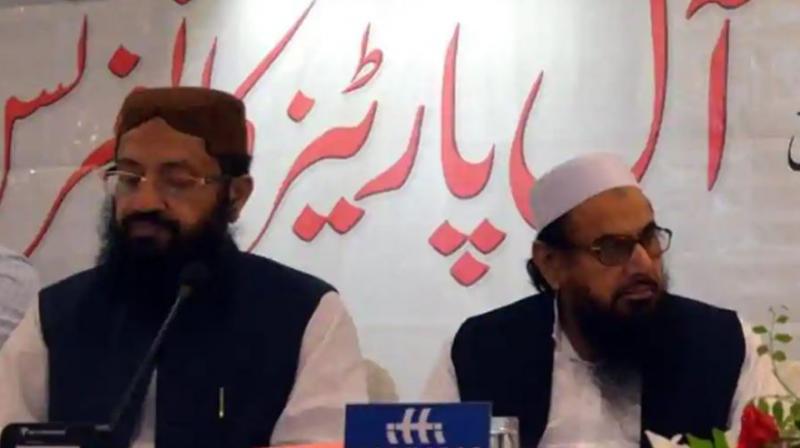 Hafiz Saeed (right) and Pakistans religious affairs minister Noor-Ul-Haq Qadri were seen together at an event in Islamabad.(Photo: Twitter | @NadeemAwan_)