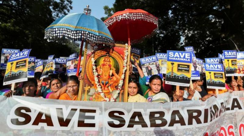 Devotees raised slogans and held pictures of Lord Ayyappa, placards as a part of their Save Sabarimala campaign steered by the state unit of BJP-led NDA. (Photo: PTI)