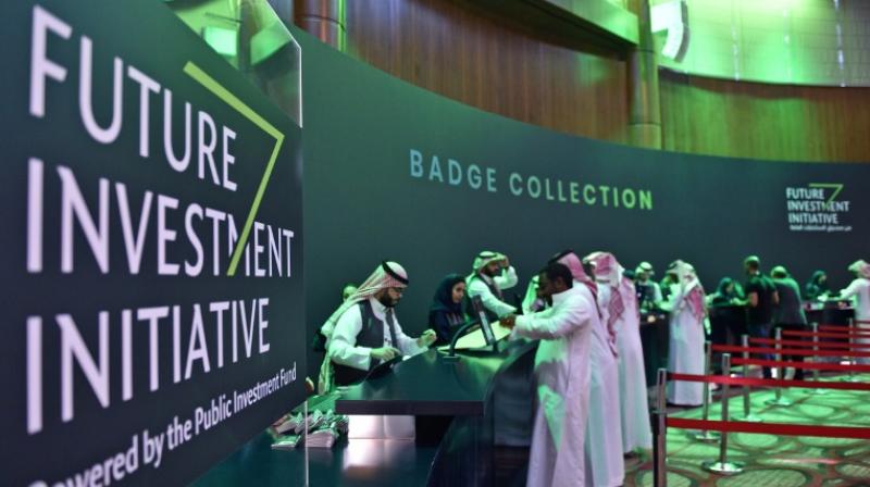 Saudi journalists collect their press badges for the Future Investment Initiative -- a key gathering overshadowed by the killing of critic Jamal Khashoggi. (Photo: AFP)