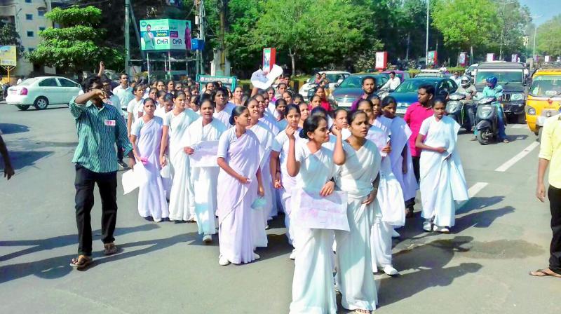 Students of government nursing college conduct a rally at Guntur on Saturday seeking suspension of principal. (Photo: DC)