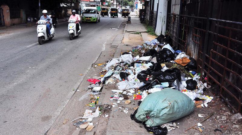 Garbage illegally dumped on a footpath on Infantry Road ( Photos:Satish.B)