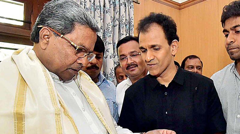 Actor Raghavendra Rajkumar with CM Siddaramaiah in Bengaluru on Wednesday. (Photo: DC)