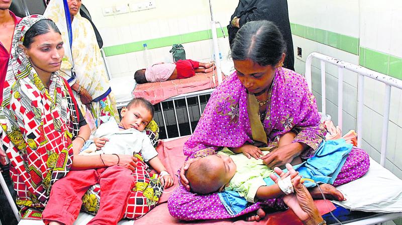 Women wait for the treatment of their kids at Gandhi Hospital.