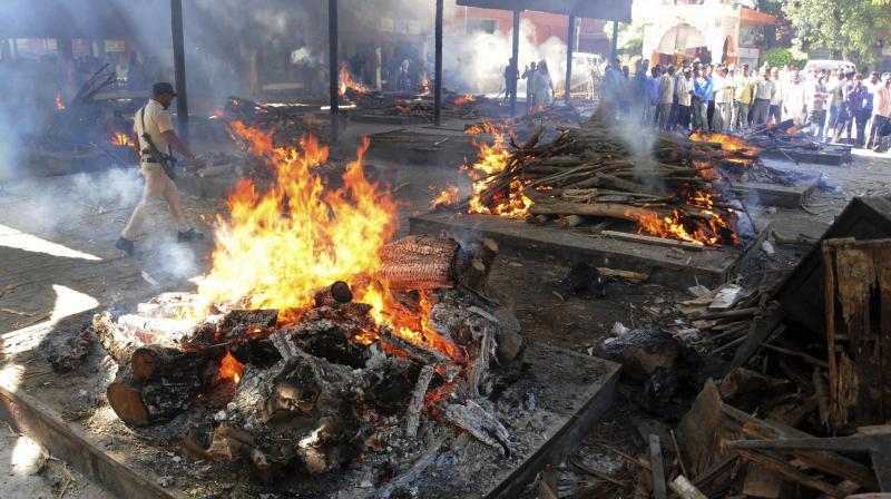 Mass funeral of victims of rail accident at Shiv Puri, Durgiana Temple in Amritsar on Saturday. (Photo: PTI)