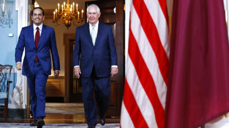 Secretary of State Rex Tillerson walks with â€ŽQatari Foreign Minister Sheikh Mohammed bin Abdulrahman Al Thani (Photo: AP)